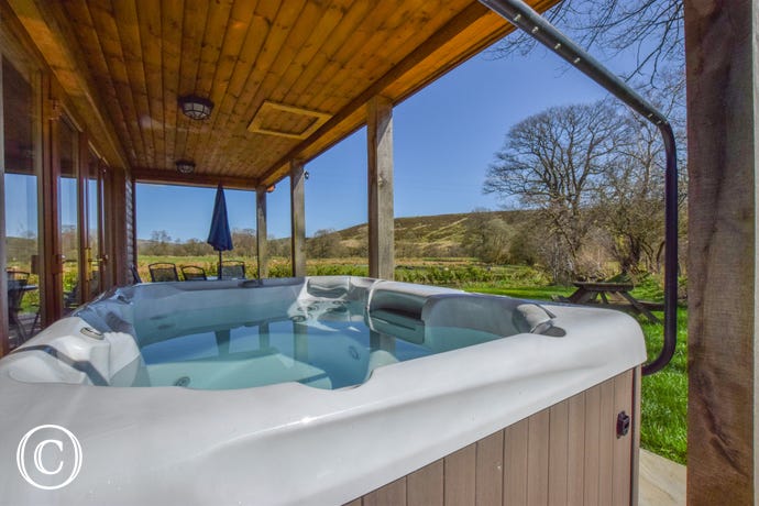 The hot tub and the view from it The hot tub and the great view from it at Llanddewi Retreat